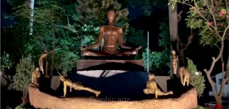 A seated Buddha garden installation by Graphic Arts on a tiered base, with attendant figures and deer across the surrounding platform